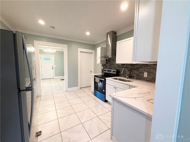 kitchen featuring a sink, wall chimney exhaust hood, backsplash, range with electric stovetop, and freestanding refrigerator