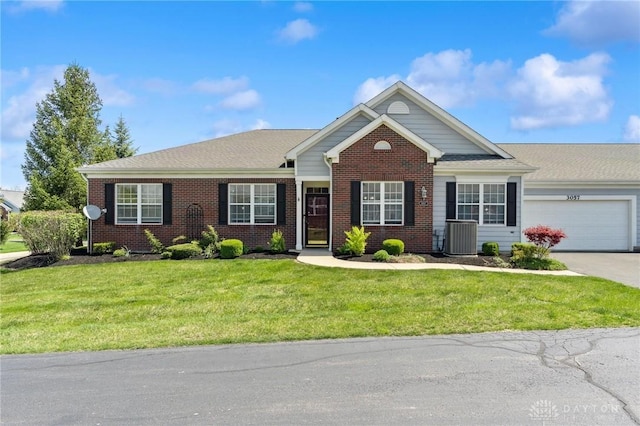 view of front of property with driveway, central AC, brick siding, a front lawn, and a garage