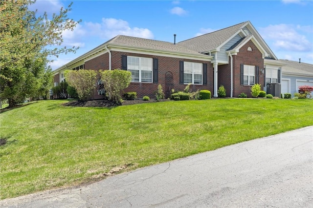 ranch-style house featuring central AC, brick siding, and a front yard
