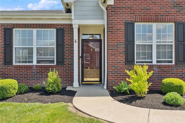 property entrance featuring brick siding