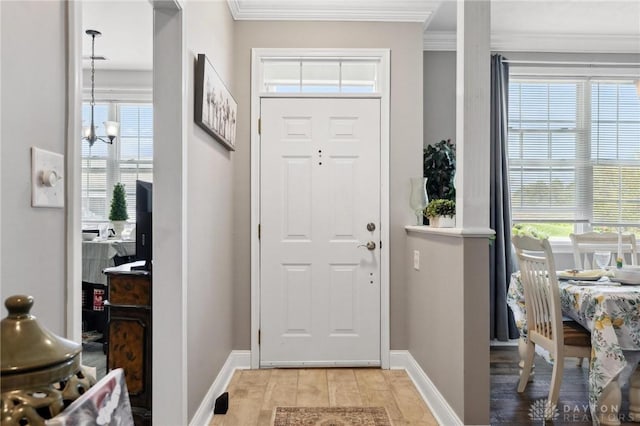 entryway featuring baseboards, a healthy amount of sunlight, and crown molding