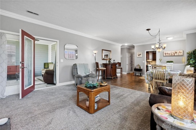 living area with baseboards, visible vents, a notable chandelier, french doors, and crown molding