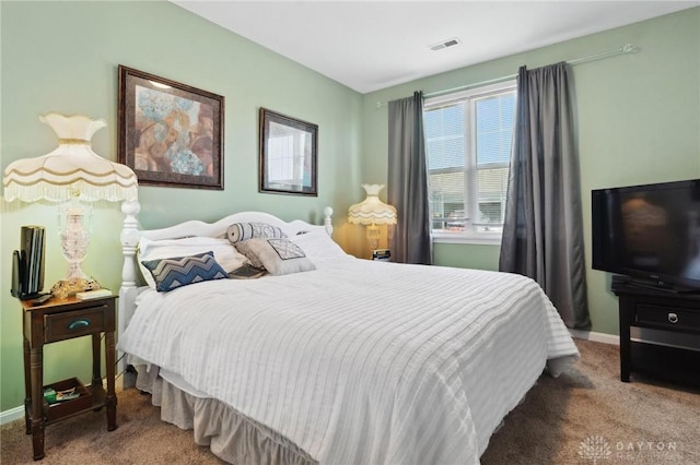 bedroom featuring baseboards, visible vents, and carpet