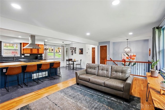 living area featuring wood finished floors, recessed lighting, and a notable chandelier