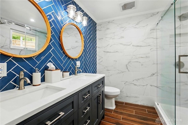 full bathroom featuring visible vents, ornamental molding, a marble finish shower, and a sink