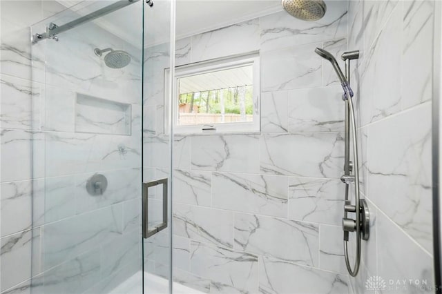 bathroom featuring a marble finish shower