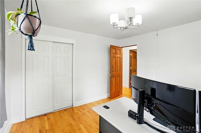 office featuring a chandelier, baseboards, and light wood finished floors