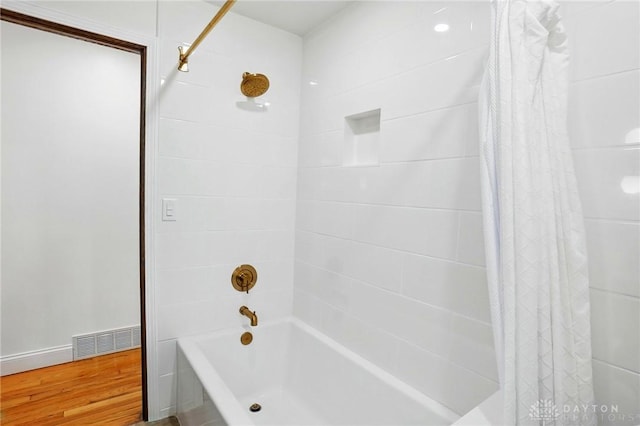 bathroom featuring visible vents and shower / bath combination with curtain