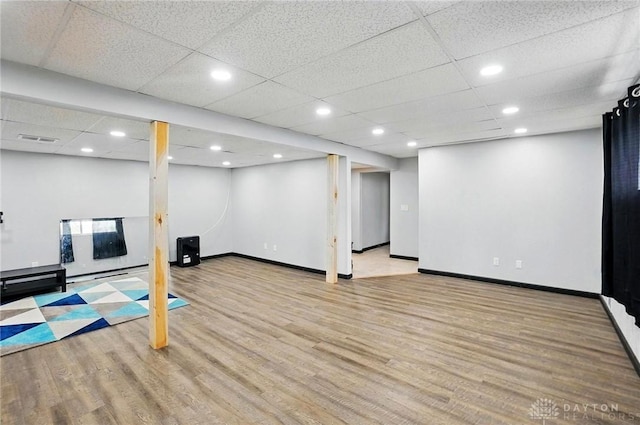 finished basement featuring recessed lighting, visible vents, wood finished floors, and baseboards