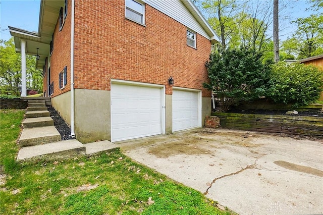 garage featuring concrete driveway