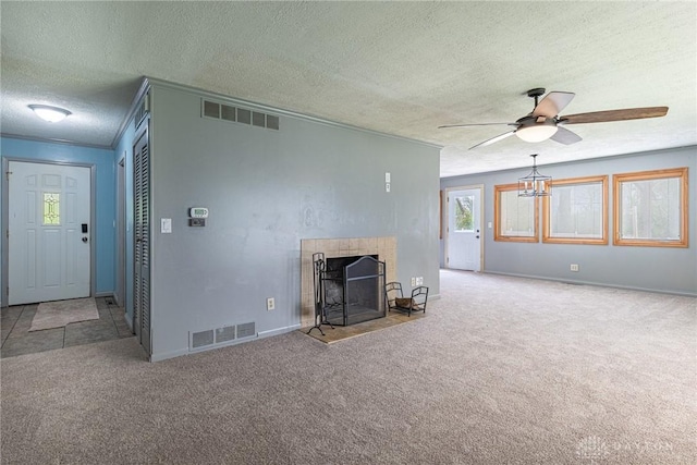 unfurnished living room with carpet, visible vents, ceiling fan, and a textured ceiling