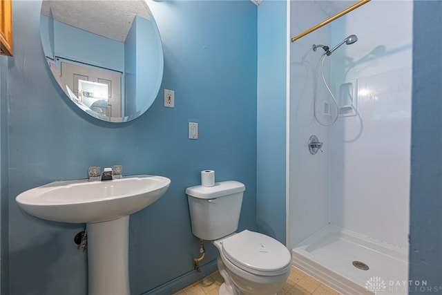 bathroom with a shower stall and toilet
