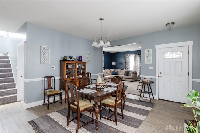14 Clemens Ave, Jamestown Vlg, OH 45335 - dining space with an inviting chandelier, wood finished floors, baseboards, and stairs