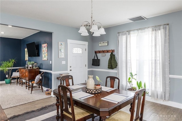 14 Clemens Ave, Jamestown Vlg, OH 45335 - dining space featuring an inviting chandelier, visible vents, wood finished floors, and baseboards