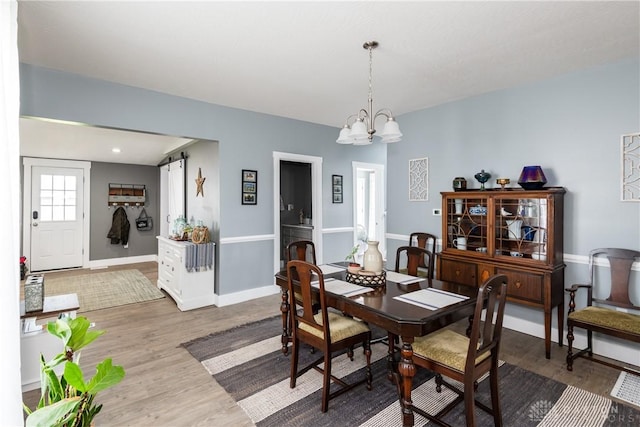 14 Clemens Ave, Jamestown Vlg, OH 45335 - dining room featuring a notable chandelier, wood finished floors, and baseboards