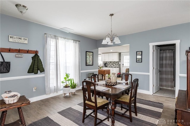 14 Clemens Ave, Jamestown Vlg, OH 45335 - dining room with wood finished floors, plenty of natural light, and a notable chandelier