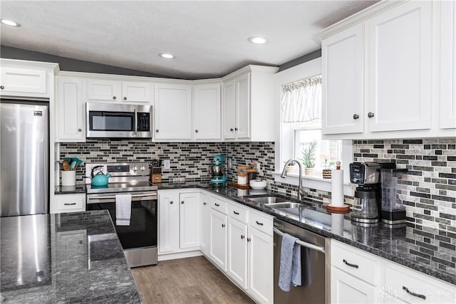 14 Clemens Ave, Jamestown Vlg, OH 45335 - kitchen with white cabinetry, appliances with stainless steel finishes, decorative backsplash, and a sink
