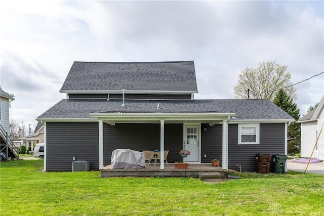 14 Clemens Ave, Jamestown Vlg, OH 45335 - back of property featuring central AC, roof with shingles, and a lawn