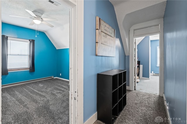 bonus room featuring carpet, lofted ceiling, a baseboard radiator, and ceiling fan