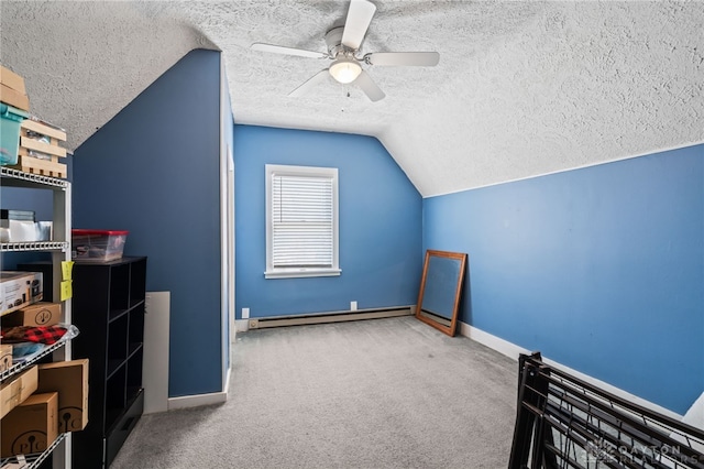 bonus room featuring carpet, a ceiling fan, a baseboard radiator, a textured ceiling, and lofted ceiling
