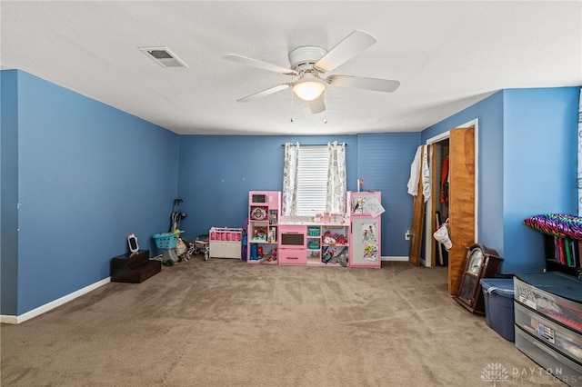 recreation room with visible vents, baseboards, ceiling fan, and carpet floors