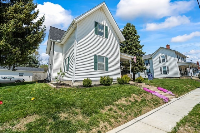 view of side of property featuring a yard