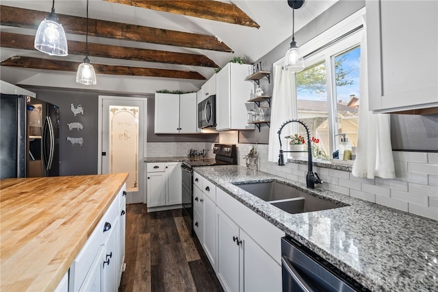 kitchen featuring a sink, butcher block countertops, black fridge with ice dispenser, backsplash, and electric range oven