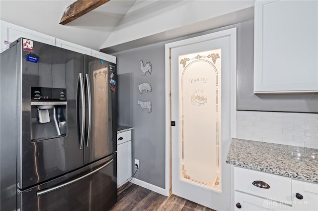 kitchen with white cabinetry, light stone counters, stainless steel refrigerator with ice dispenser, and dark wood-style floors