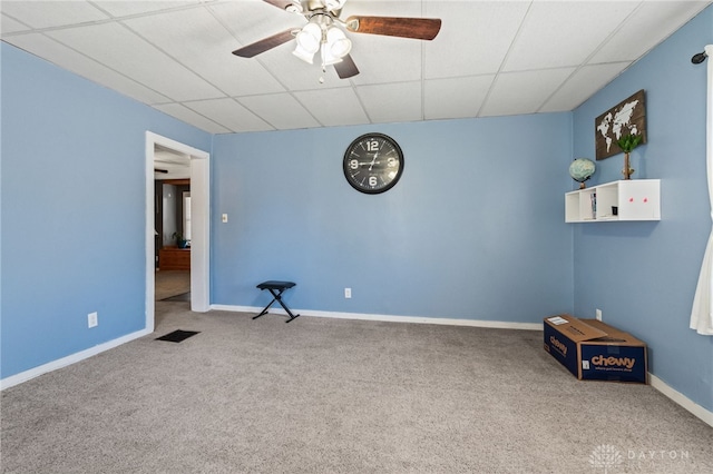 spare room featuring a paneled ceiling, ceiling fan, and carpet floors