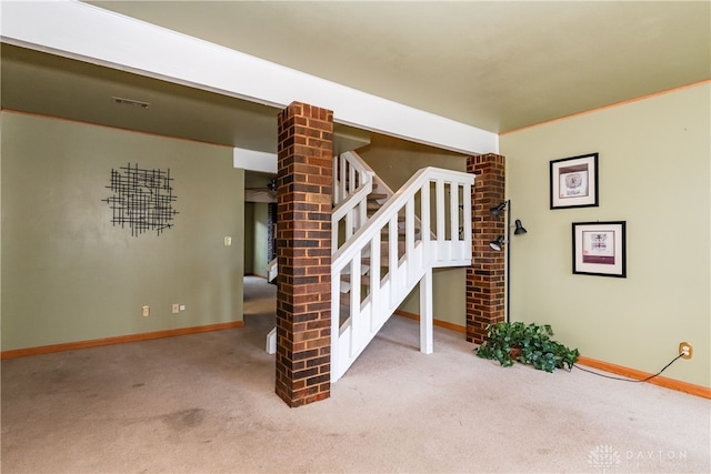 stairway featuring carpet flooring and baseboards