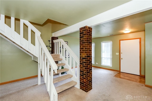 stairway with baseboards and carpet floors