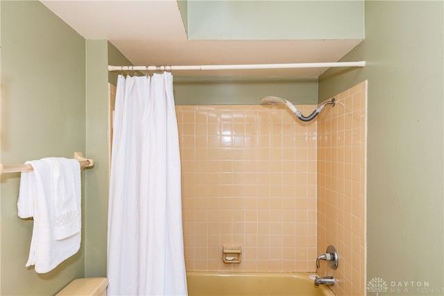 bathroom with shower / tub combo and toilet