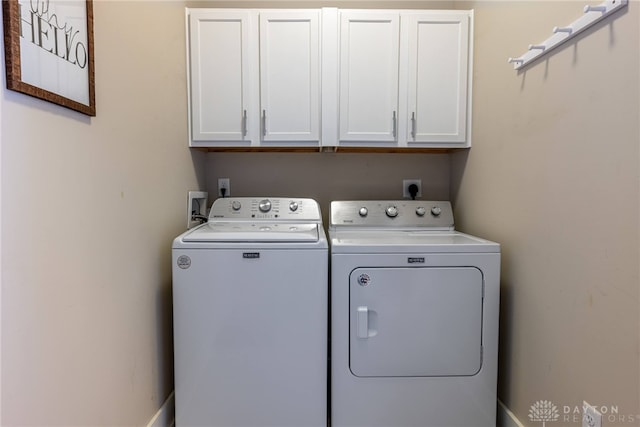 laundry area with cabinet space and washer and clothes dryer