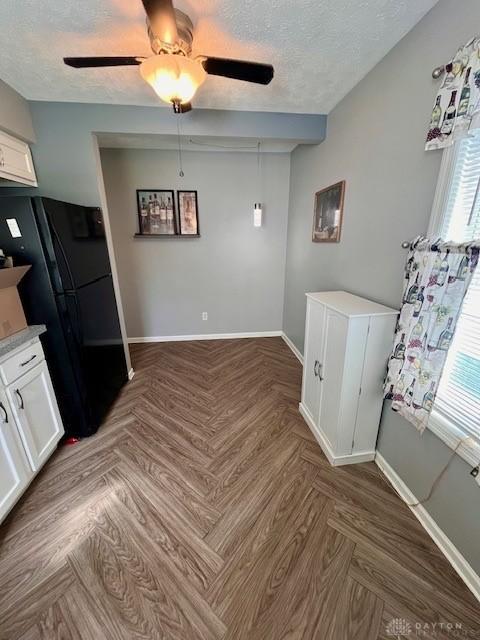 1331 Malden Ave, Springfield, OH 45504 - unfurnished dining area featuring a ceiling fan, a textured ceiling, and baseboards