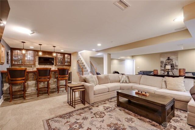 living area featuring baseboards, recessed lighting, stairway, wet bar, and visible vents
