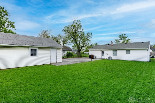 rear view of property with a patio and a lawn