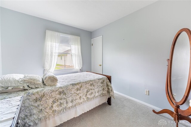 bedroom with carpet and baseboards