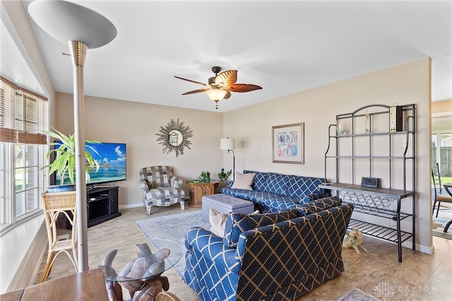 living room featuring ceiling fan and baseboards