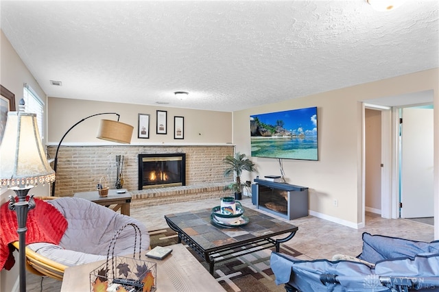 living room with baseboards, visible vents, a textured ceiling, and a brick fireplace