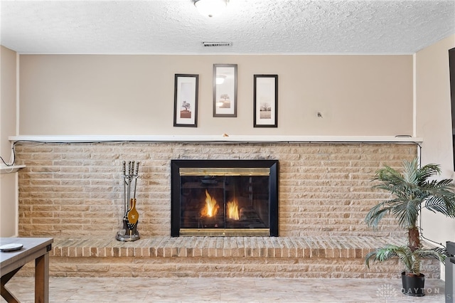 details featuring a textured ceiling, visible vents, and a fireplace