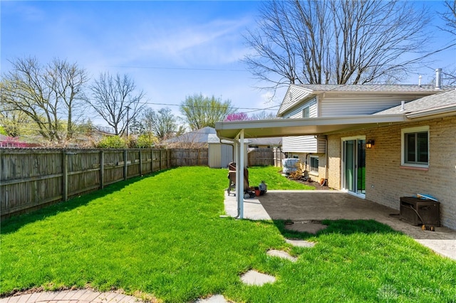 view of yard featuring an outdoor structure, a patio, a storage shed, central AC, and a fenced backyard