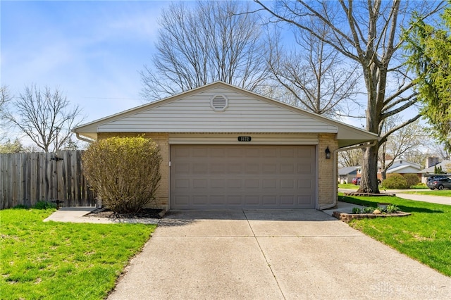 view of front of home with brick siding, fence, a front yard, and concrete driveway
