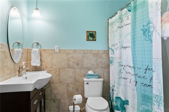 bathroom featuring toilet, tile walls, vanity, and a shower with shower curtain