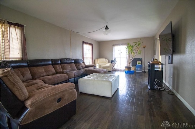 living area featuring dark wood-style floors and baseboards