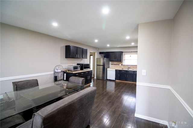 dining space with a toaster, recessed lighting, dark wood finished floors, and baseboards