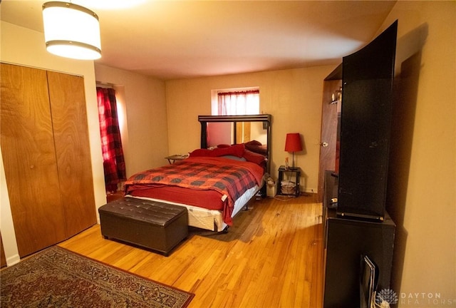 bedroom featuring wood finished floors and a closet