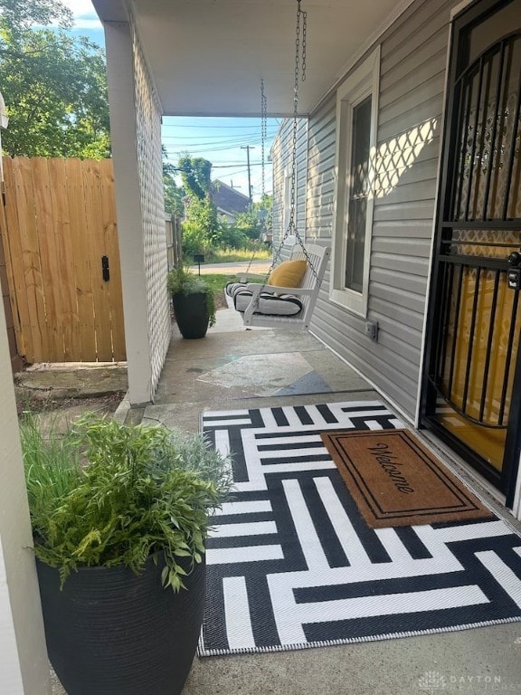 view of patio / terrace featuring covered porch and fence