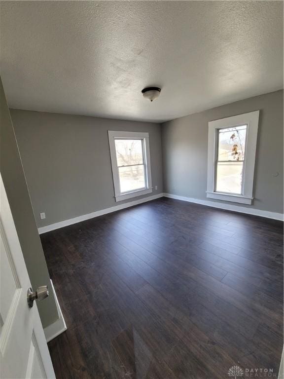 66 Barnett St Unit 64, Dayton, OH 45402 - unfurnished room with a textured ceiling, dark wood-style floors, and baseboards