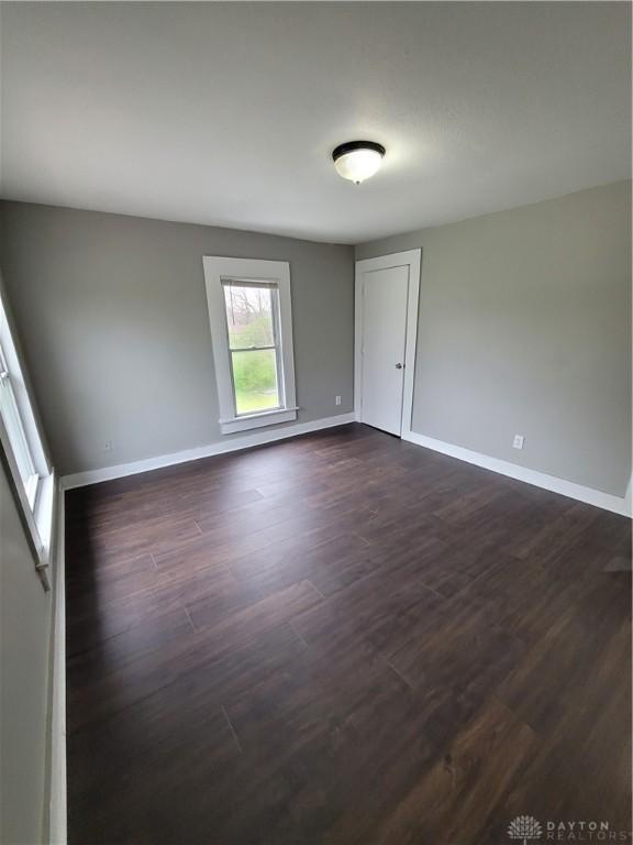 66 Barnett St Unit 64, Dayton, OH 45402 - empty room featuring baseboards and dark wood finished floors
