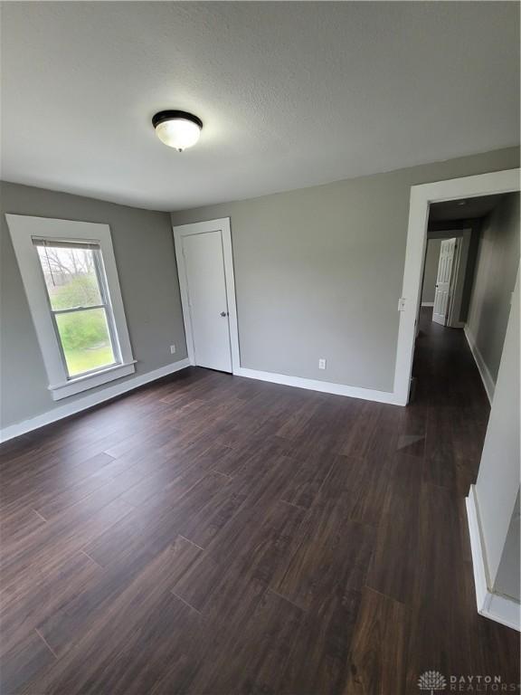 66 Barnett St Unit 64, Dayton, OH 45402 - unfurnished room with dark wood-type flooring and baseboards